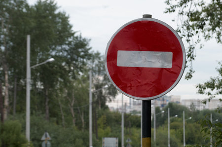 Road sign "no entry" against the background of tree branchesの写真素材