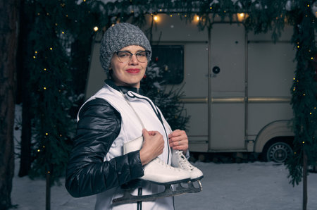 Woman with skates on the background of Christmas decorの写真素材