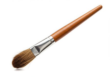 A paint brush with a wooden handle and silver ferrule is displayed on a white background. The bristles are brown and neatly arranged, suitable for painting and art projects. Studio shot, close up.の素材