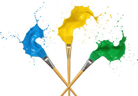 Three paintbrushes with vibrant blue, yellow, and green paint splashes. The brushes are arranged in a visually appealing composition, showcasing the dynamic and colorful nature of artistic expression.の素材
