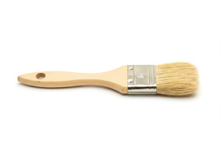 A paint brush with a wooden handle and light bristles is displayed against a white backdrop. The brush is clean, showing its natural wood grain and the texture of the bristles, ready for artistic use.の素材