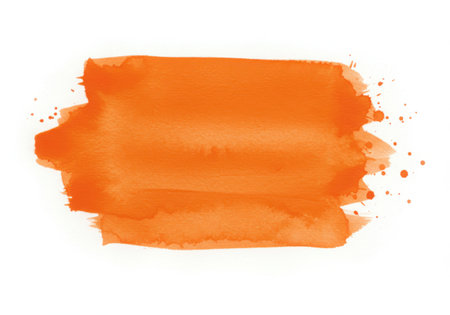A vibrant orange watercolor brush stroke with splatters, isolated on a white background. Perfect for adding an artistic touch to designs and illustrations, with a handmade feel.の素材
