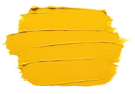 A vibrant yellow paint stroke with a visible brush texture. The thick application of paint creates a bold and artistic smear, perfect for adding a pop of color and texture to designs. Isolated on a white backdrop.の素材