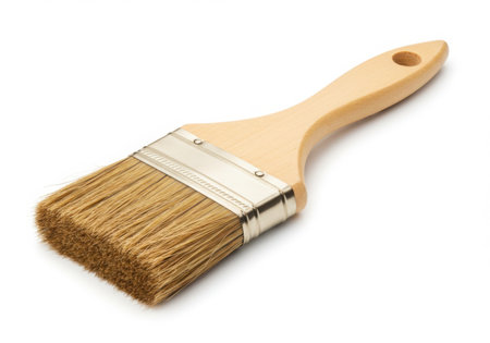 A paint brush with a wooden handle and bristles is displayed on a white background. The brush is clean and unused, suggesting readiness for painting projects and artistic endeavors. The image is well-lit.の素材