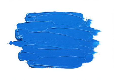 A vibrant blue paint stroke with a textured surface, applied with a brush. The acrylic paint shows clear brush marks, creating an artistic element on a white background, perfect for design backdrops.の素材