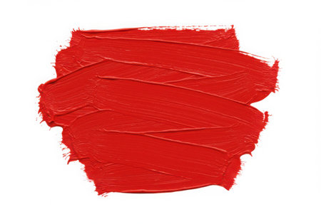 A vibrant red paint stroke with a textured surface, applied with a brush. The smear of acrylic color creates an artistic element against a clean white background, perfect for design and creative projects.の素材