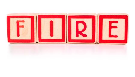 Childrens bright red building blocks spelling the work fireの写真素材