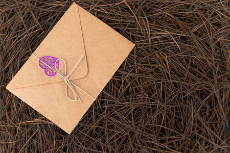 a yellow card or envelope or letter for the special day a purple heart tied with string.dried pine...