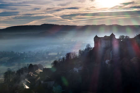 Castle in France during sunset with small town on backgroundのeditorial素材