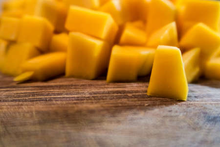 Chopped butternut squash looks like mango texture and color on wood cutting tableの写真素材