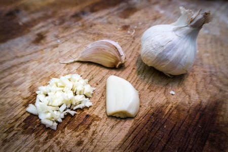 Garlic being chopped at different stage of the chopping process.の写真素材