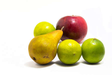Red apple, three lime and a pear all looking very natural not perfect but still shiny and tasty !の写真素材