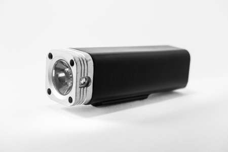 Black torch lamp with alluminium front and front glass to transmit light.
