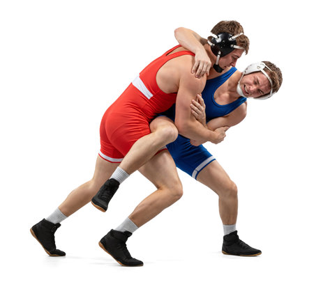 Two young male wrestlers in a grappling hold on isolated white backgroundの素材