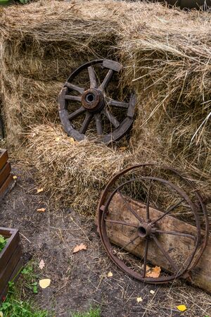 Installation of iron and wooden wheels in hayの写真素材