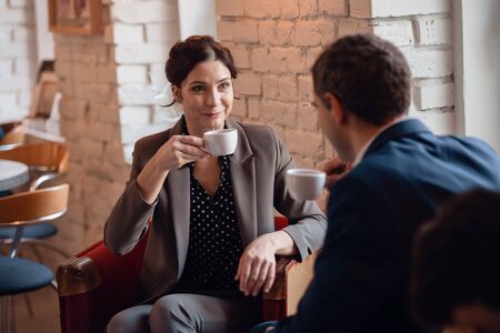 Business woman and business man having a meeting in a cafeの写真素材