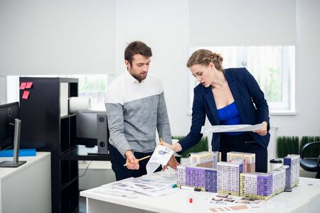 Young architect bureau employees discussing the construction project
