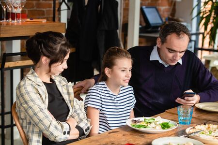 Young family chatting at the diiner table