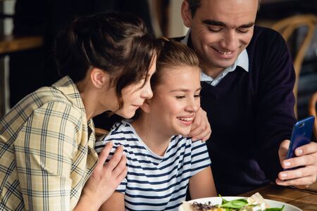 Young family chatting at the diiner tableの写真素材