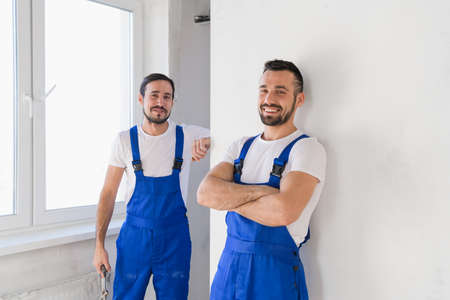 Two foremen in uniform look at the cameraの写真素材