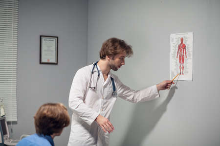 Healthcare and medicine concept - a doctor with his patient in a consultation roomの写真素材