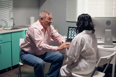 A worried patient asking the doctor questions about his diagnosis