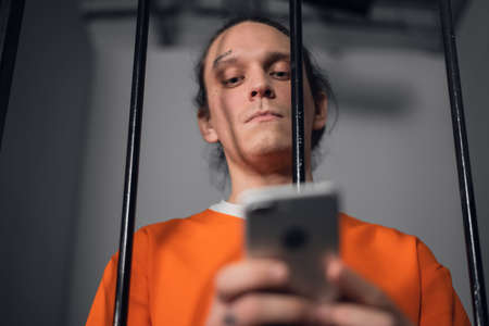 A dangerous criminal with tattoos on his face in prison got a smartphone to commit cyber crimes over the Internetの写真素材