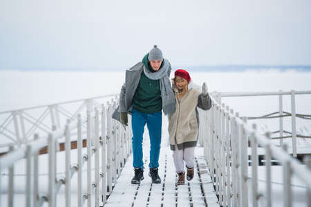 Romantic rendezvous of two lovers on valentines day on a pier on a frozen river.の写真素材