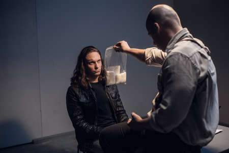 A detained white man with long hair receives irrefutable evidence of his guilt from a criminal...