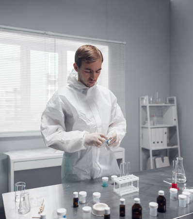 A researcher doing a chemical test in the laboratory, mixing some substances.の写真素材