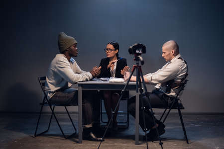 The camera captures the interrogation of a criminal arrested for selling drugs in a nightclub.の写真素材