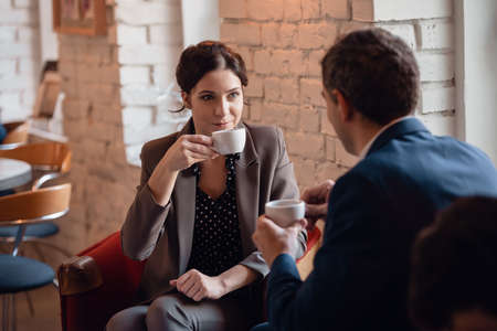 A manager having a meeting with his colleague at the coffee point.の写真素材