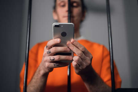 The criminal in the prison cell received a smartphone to communicate with relatives