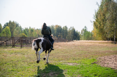 Horse ride of a young girl in places with beautiful autumn countryside landscapes.