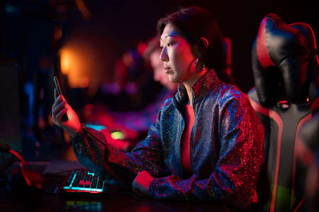 In the computer club, a young girl is talking to friends via video link directly from the gaming...