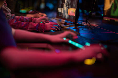 Gamers play on computers, close up of hands and keyboardの写真素材