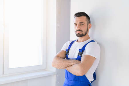 Man in blue overalls folded his arms over his chestの写真素材