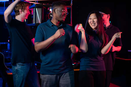 Multi-racial team of esports players celebrates the victory in the next championship