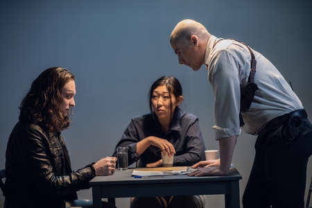 An experienced investigator and his assistant conduct an interview at the police stationの写真素材
