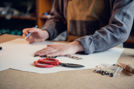 Manual production of shoes in the workshop the shoemaker begins with the preparation of a drawing...