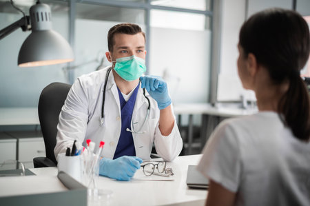 Before the flu epidemic, the doctor shows his patient the vaccine that she will be vaccinated withの写真素材