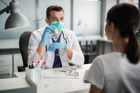 Before the flu epidemic, the doctor shows his patient the vaccine that she will be vaccinated withの写真素材