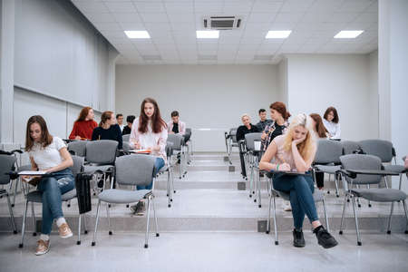 Student activities at a summer campsite, young people listen to a lecture on ecology while in the college auditoriumの写真素材