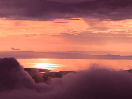 Sea sunset with islands, mountains and clouds