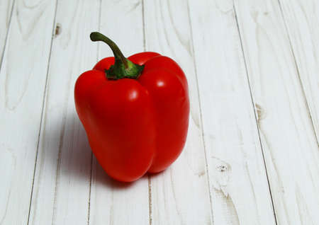 Large red bell peppers on a white Boardの写真素材