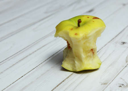 The Apple stub stands on a white table.の写真素材