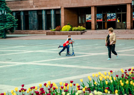05 14 2019 Russia, Bryansk. Teenagers compete in speed on scooters in the city square.のeditorial素材