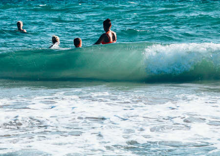 Storm at sea. A large wave covers the mother and children.のeditorial素材