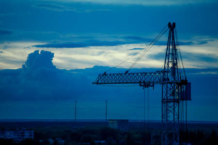 View high-rise tower crane on the background of the evening.の写真素材