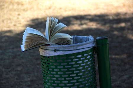 A book near waste basketの写真素材